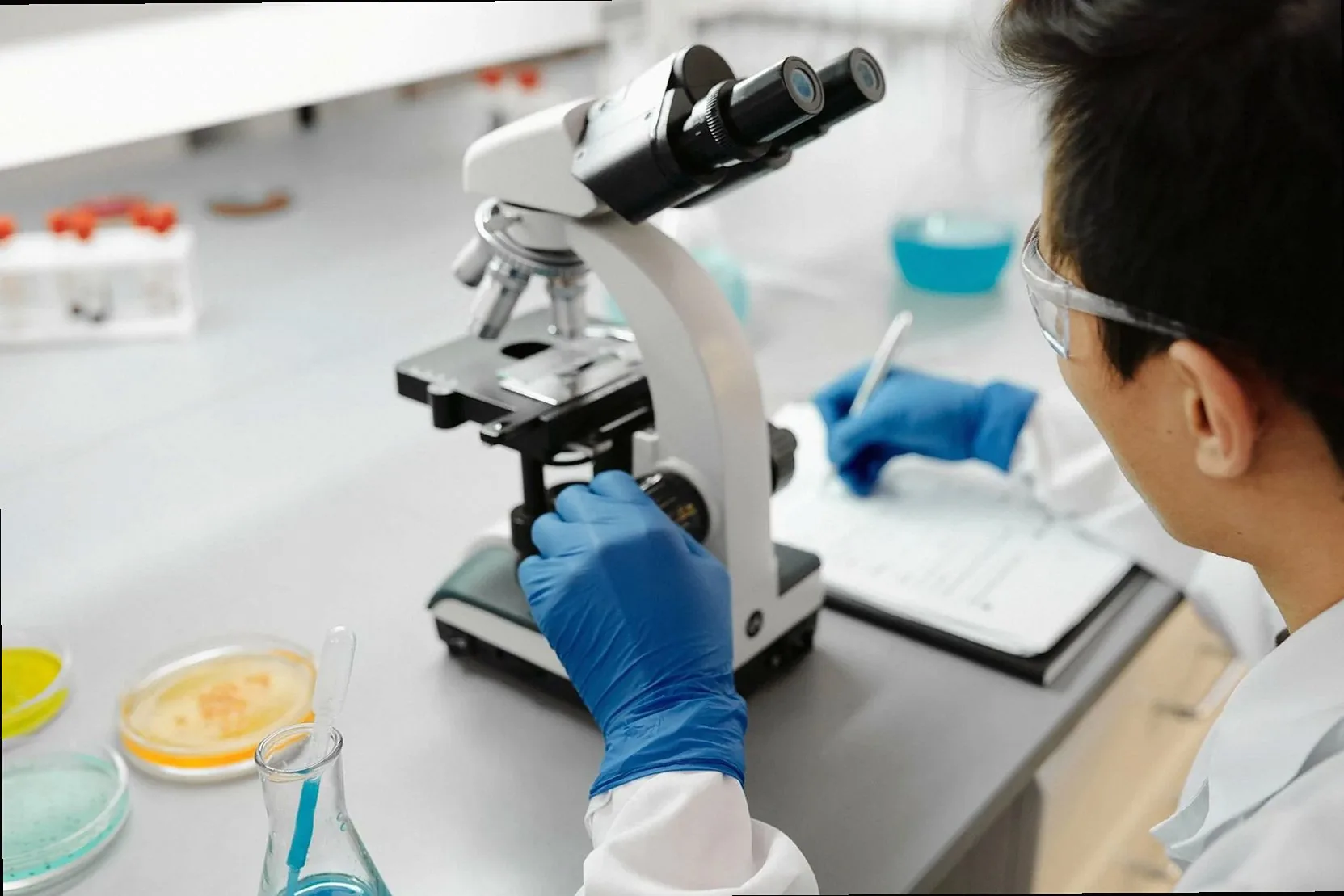 Analyst working at a microscope in the lab