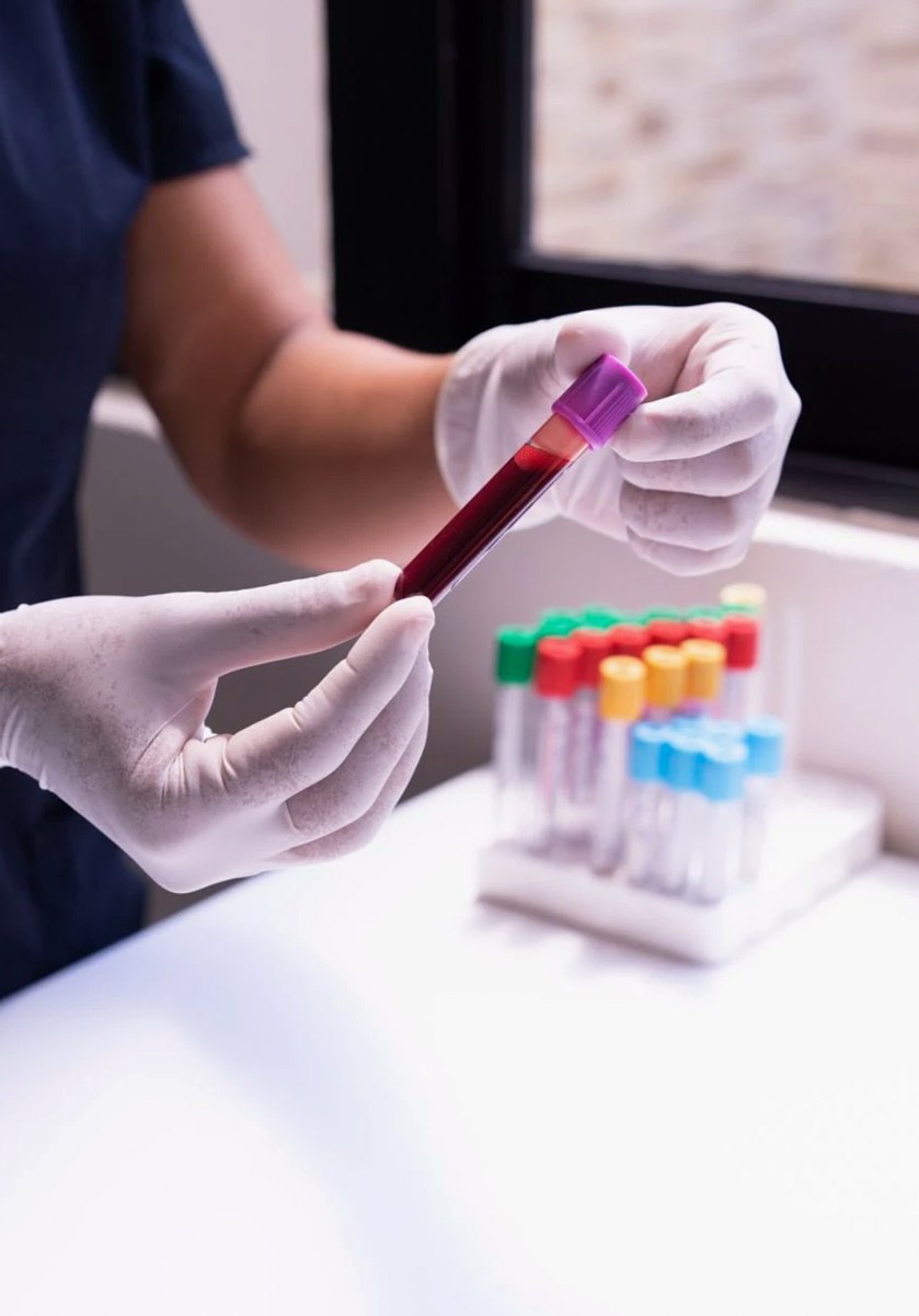 Technician holding a capped sample tube